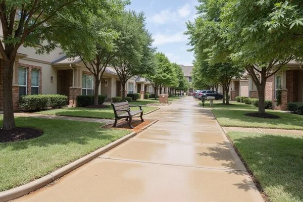 HOA common area concrete walkway in Austin freshly pressure washed and color sealed for slip-resistant maintenance