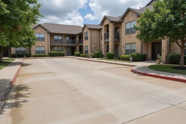Multi-family residential complex in Austin with freshly sealed parking lot concrete showing restored color and stain protection