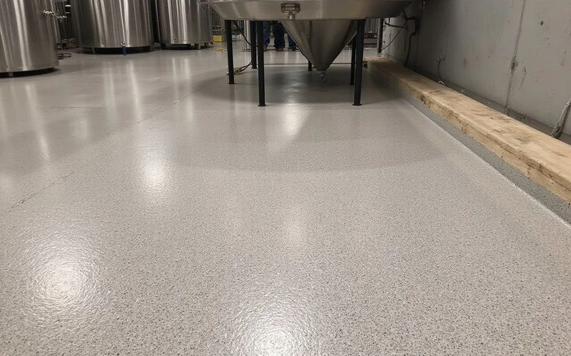 100% solids epoxy brewery production floor with quartz aggregate and coved base installed in Austin TX